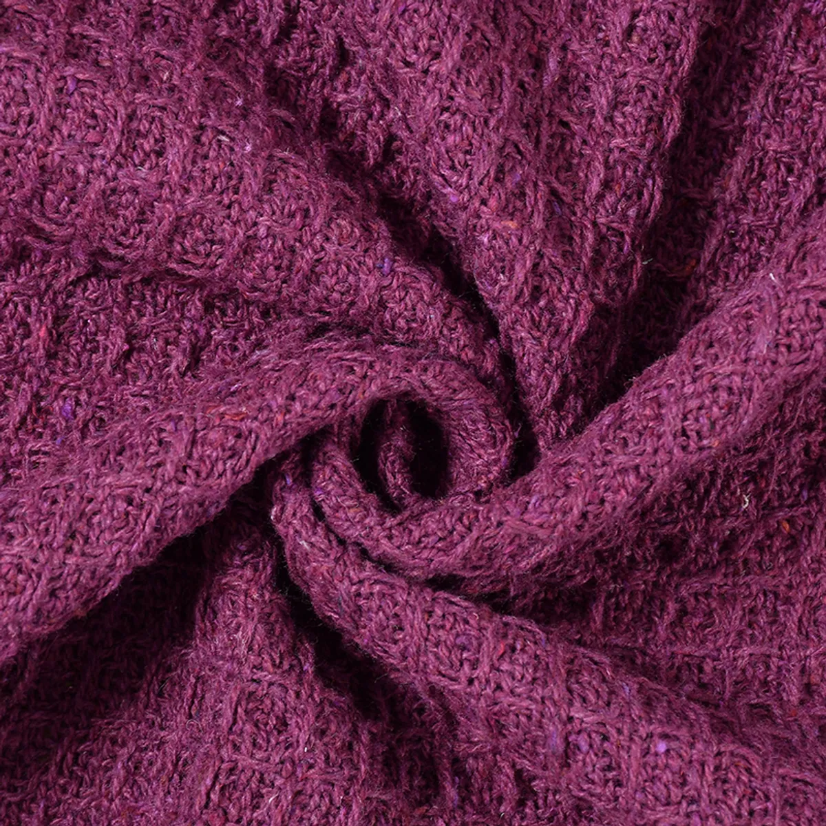 Close-up of purple textured woven throw fabric