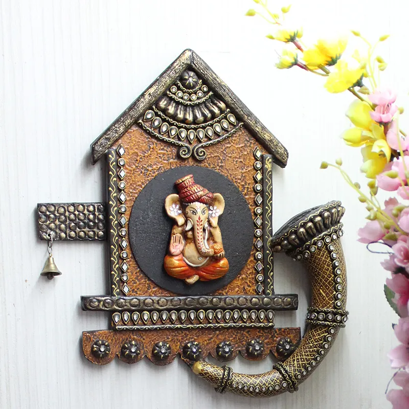 Front view of ornate Ganesha wall accent with textured brown and black finish