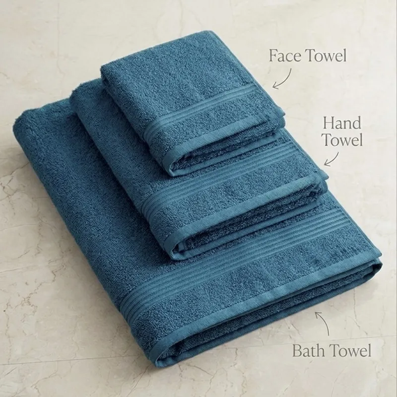 Stacked teal bath, hand and face towels