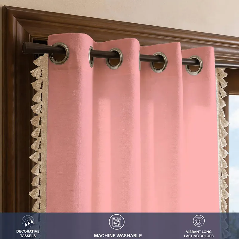 Close view of pink curtain with eyelets and tasselled border