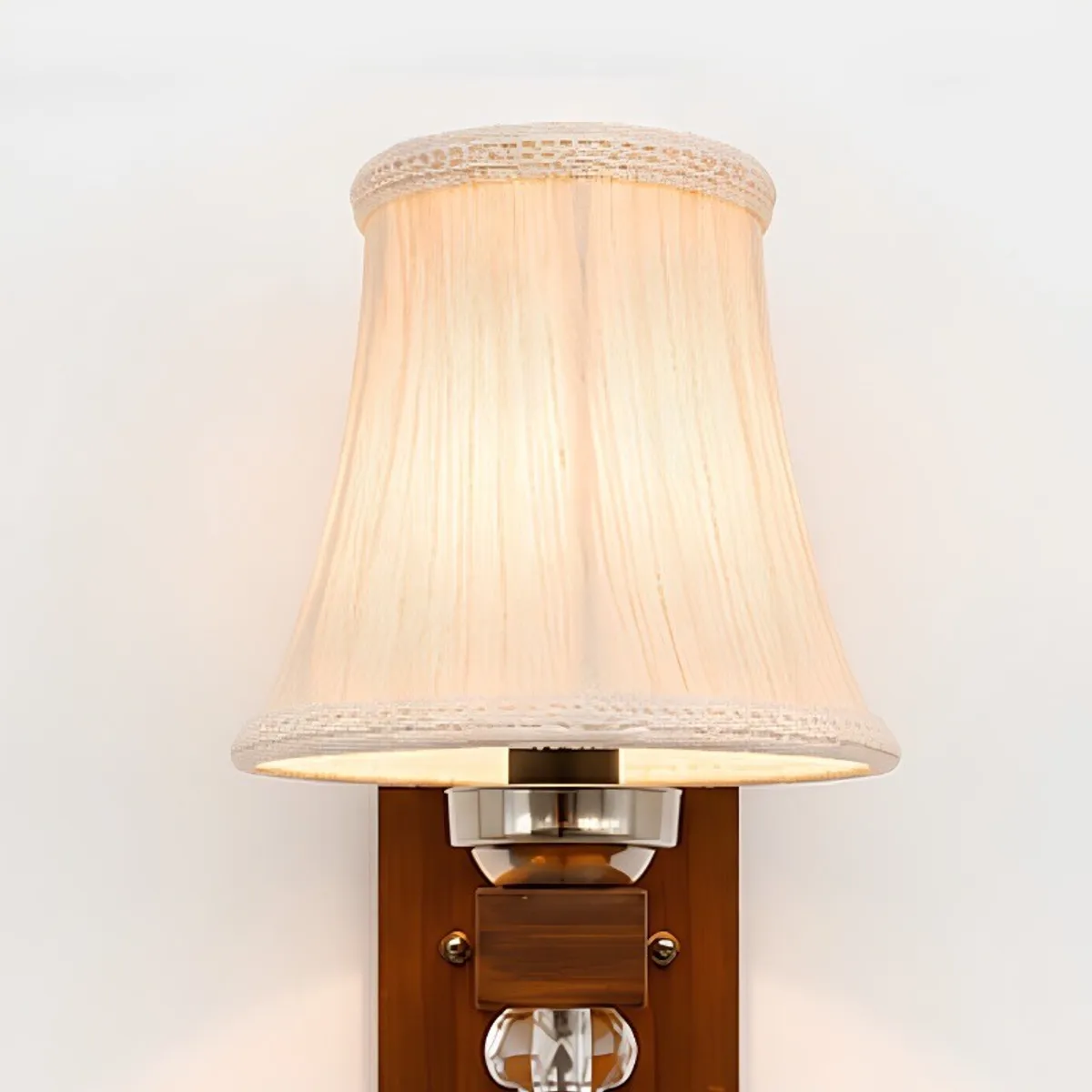 Front view of a pleated white cotton wall lamp with wooden base