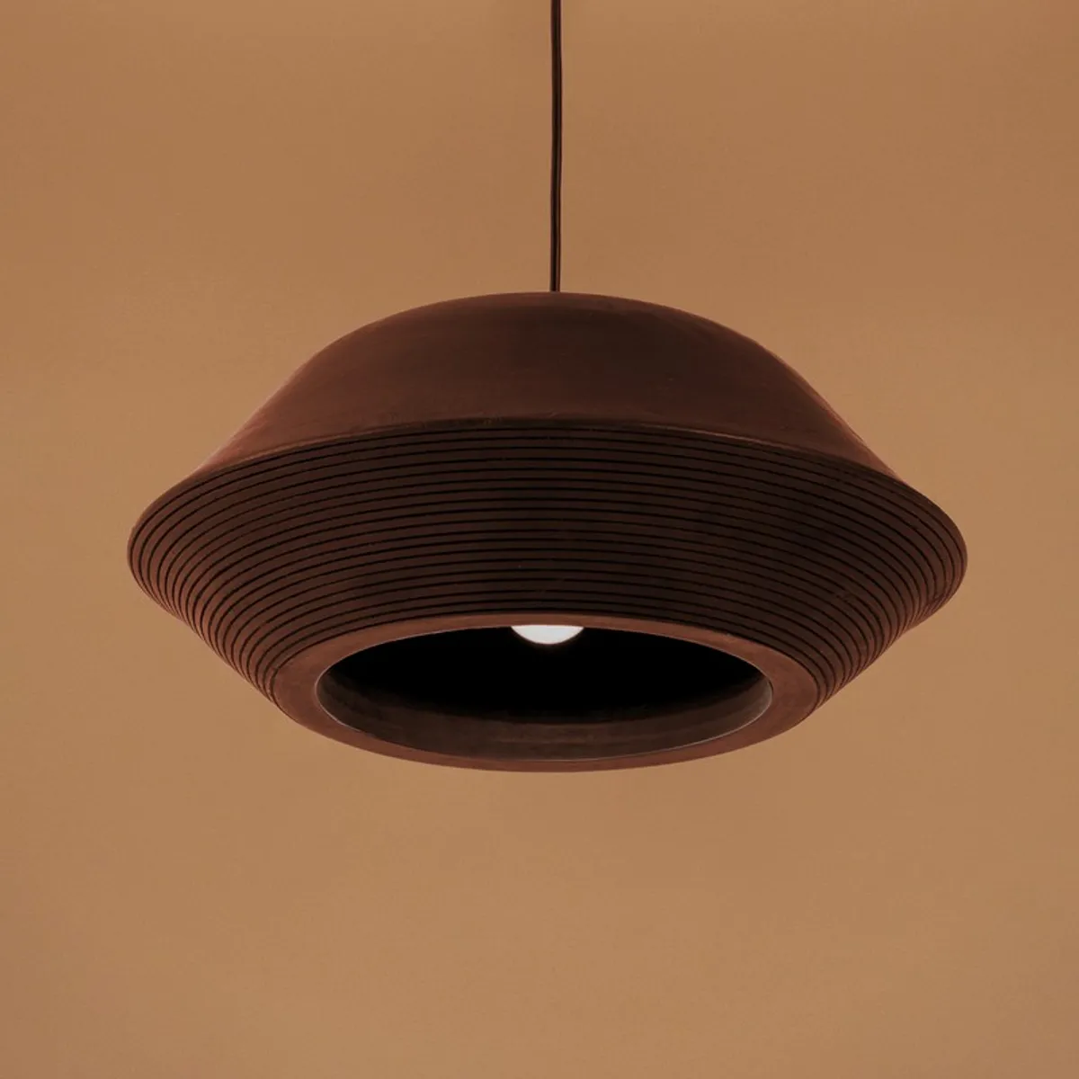 Underside view of the black ceiling lamp showing the inner opening