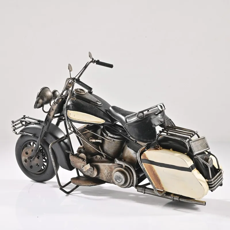Studio view of black vintage motorcycle showpiece with cream side panels