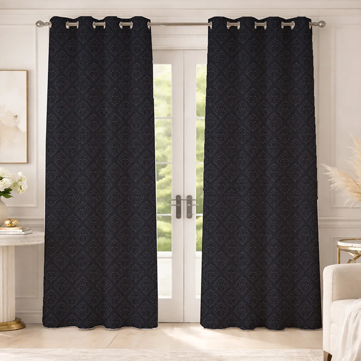 Set of two black patterned eyelet curtains hung over a glass door