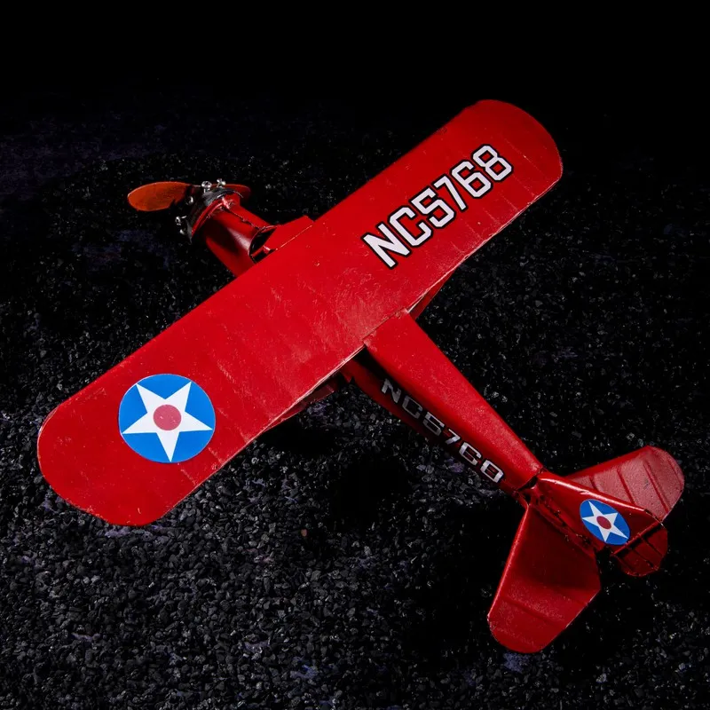 Top view of a red aeroplane showpiece with vintage markings