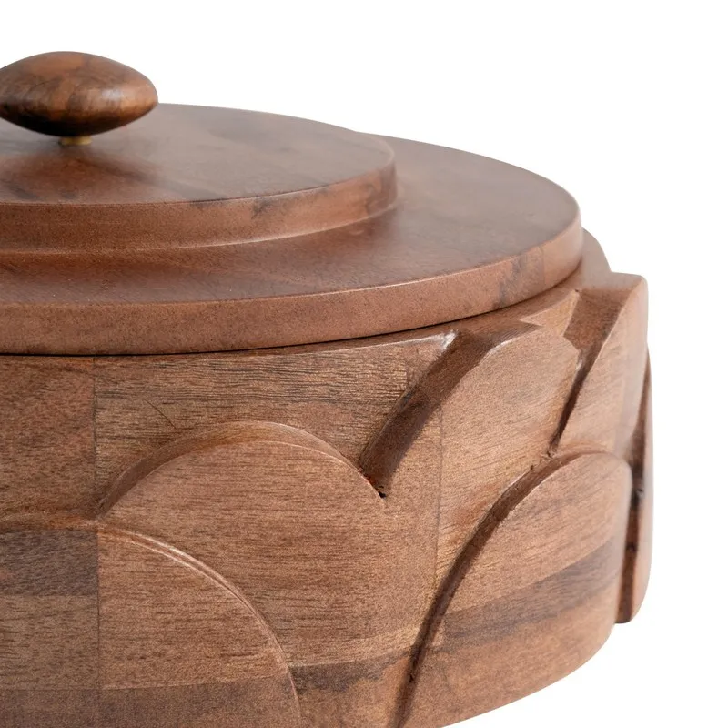 Close-up of the glossy brown wood surface and carved petal-arch detailing on the masala box.