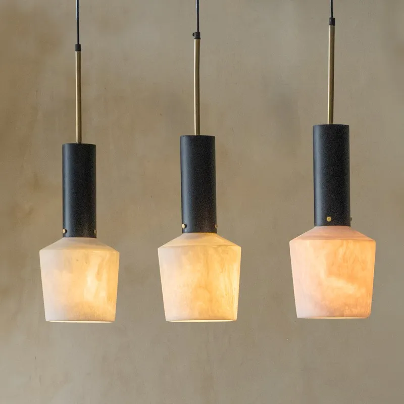 Close view of three hanging pendants with black and off-white finish