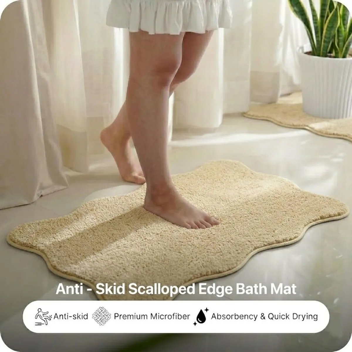 Person standing on a beige scalloped bath mat in a bright bathroom