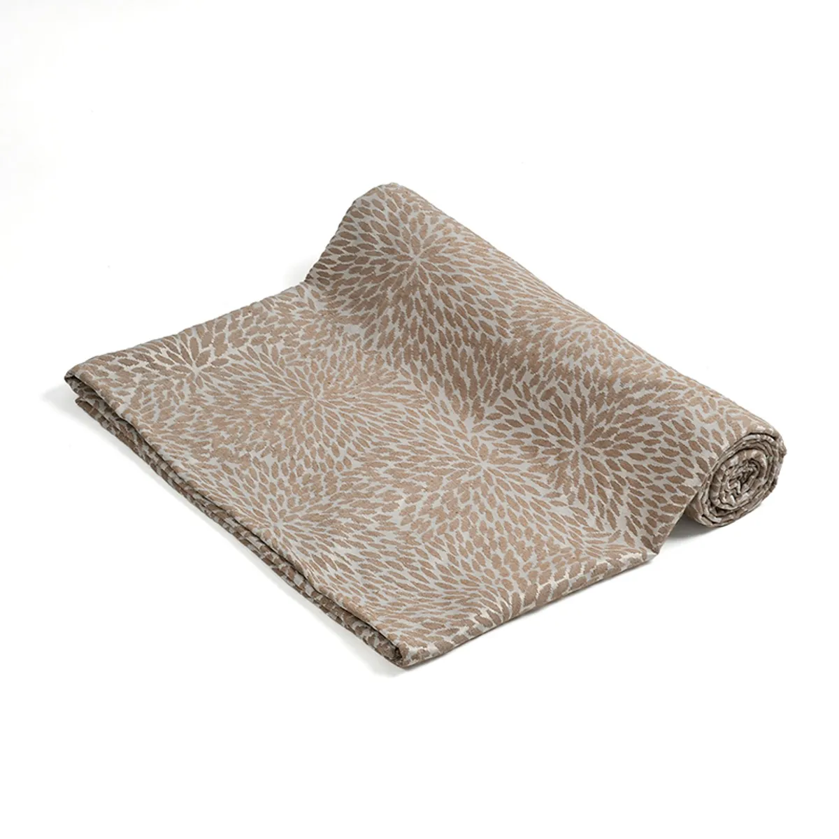 Partially rolled brown and cream patterned throw on a plain background