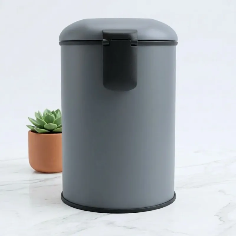 Rear view of grey cylindrical dustbin with black back handle