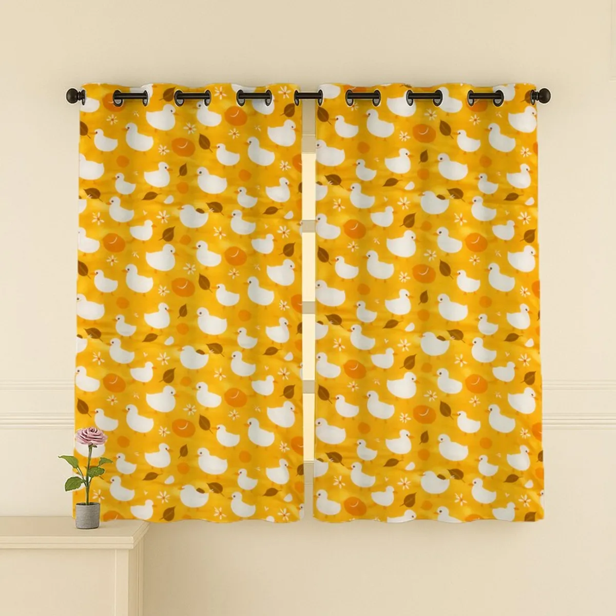 Pair of yellow duck print curtains hung across a window