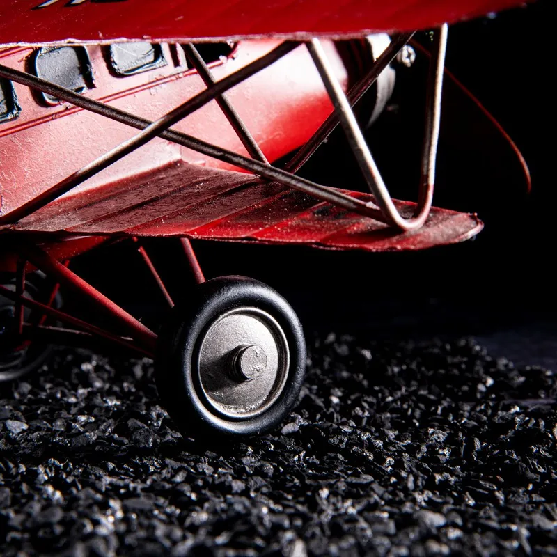 Close-up of the red aeroplane showpiece wheel and wing details