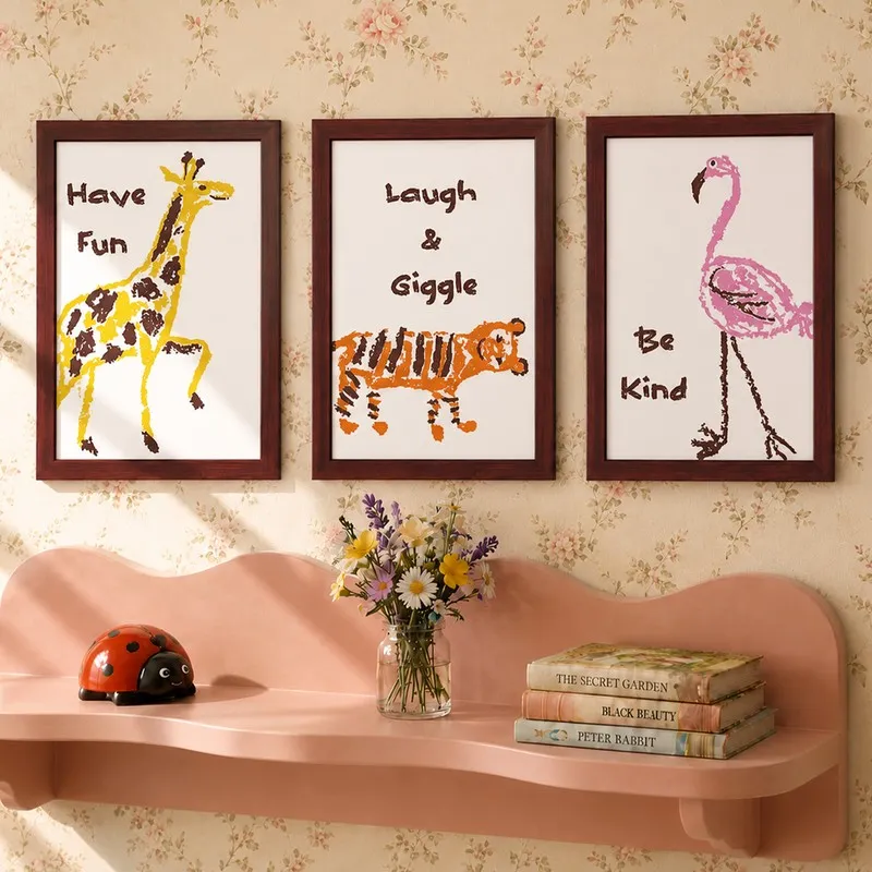 Three framed animal prints with playful text on a floral wallpapered wall