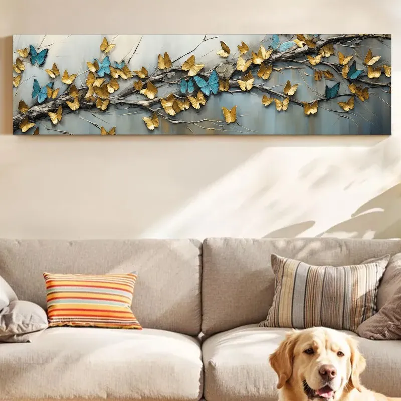 Rectangular butterfly wall art above a sofa with a dog resting in front