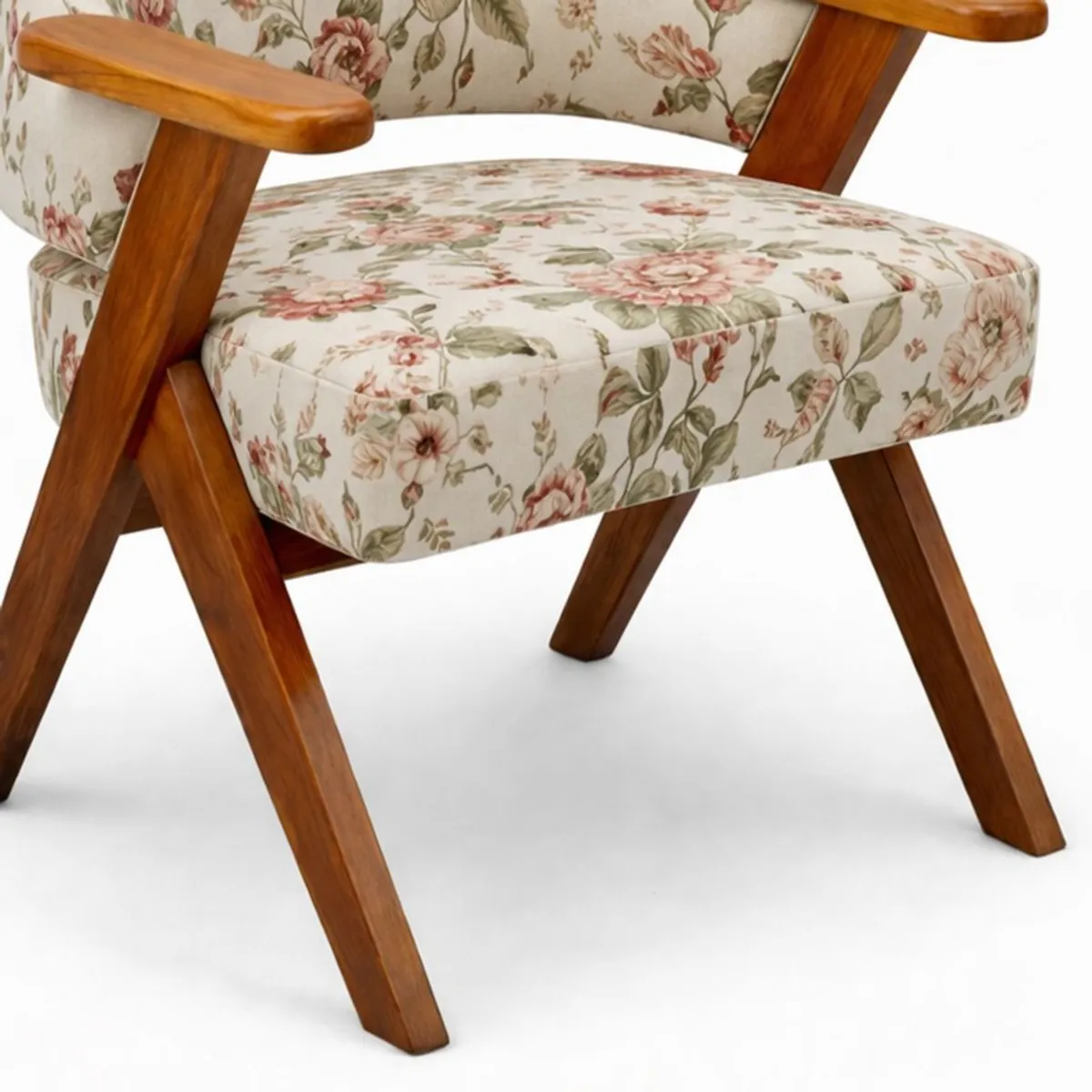 Close-up of the floral velvet seat, wooden arm and angled teak leg