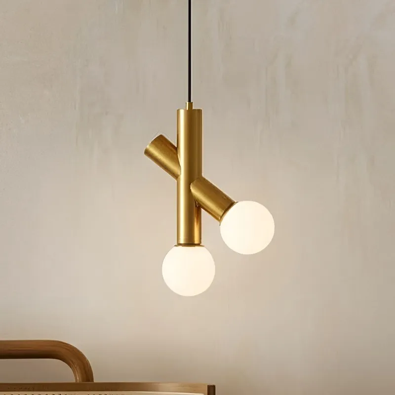 Close view of gold ceiling lamp with two white globe shades