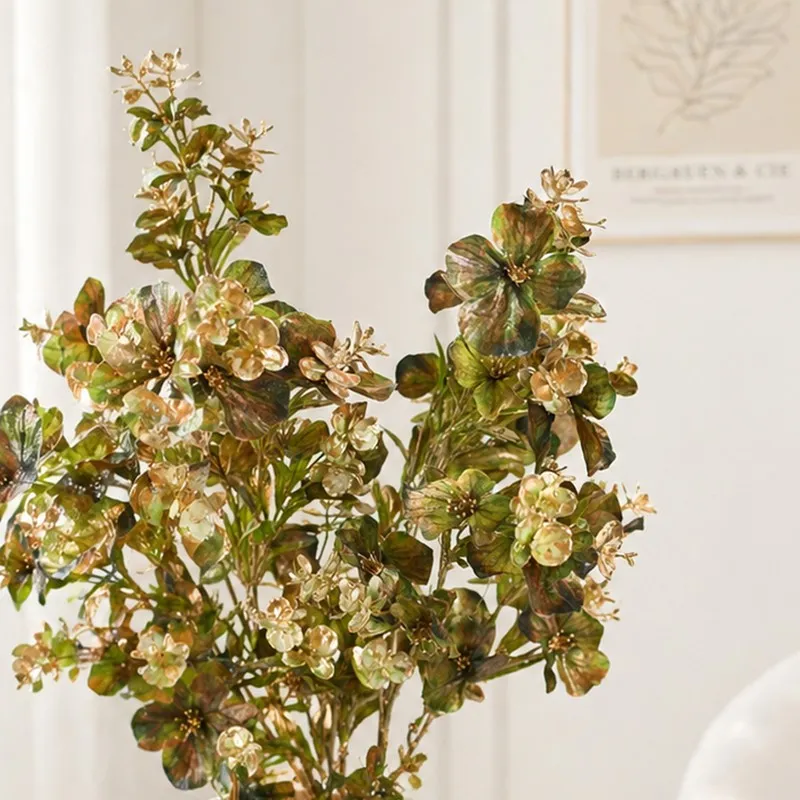 Close-up of green and yellow artificial floral stems with delicate blooms
