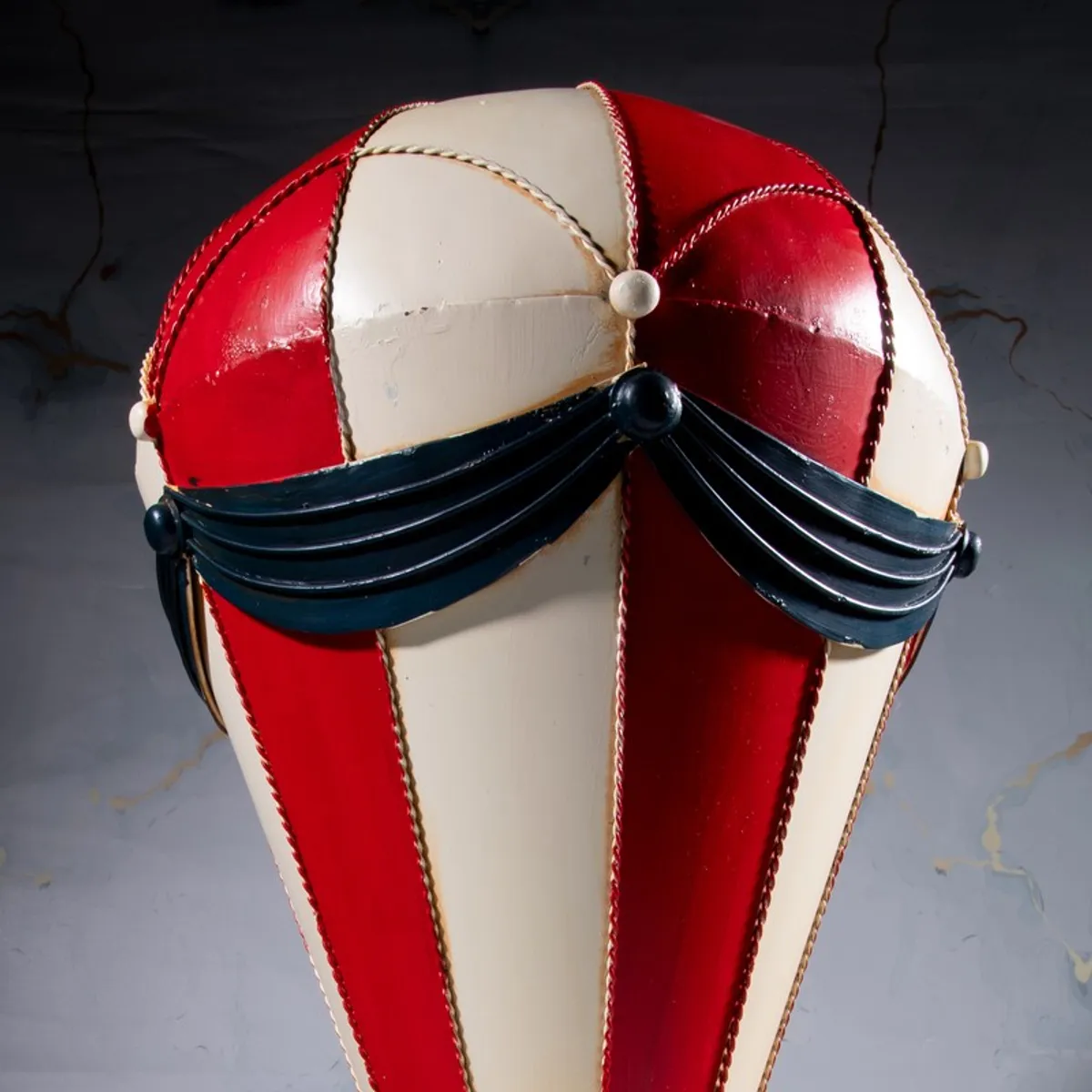 Close-up of red and cream balloon top with black draped detailing
