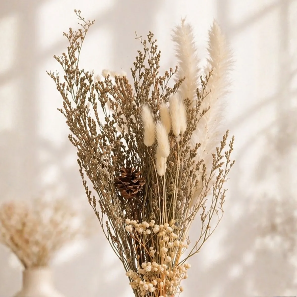 Close-up of a dried bouquet with delicate stems, fluffy accents and small blossoms