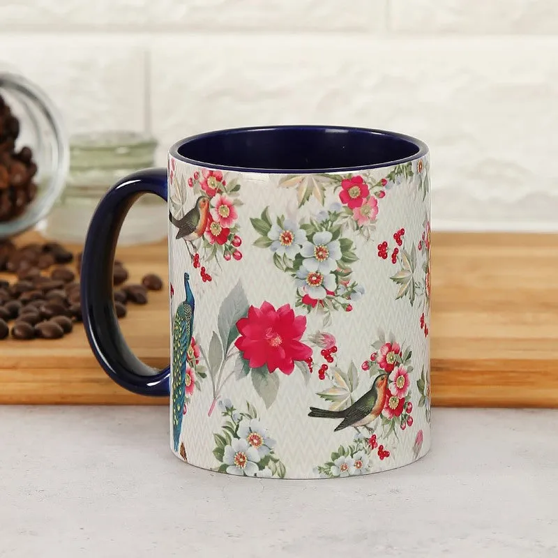 Front view of a floral ceramic mug with colourful bird illustrations