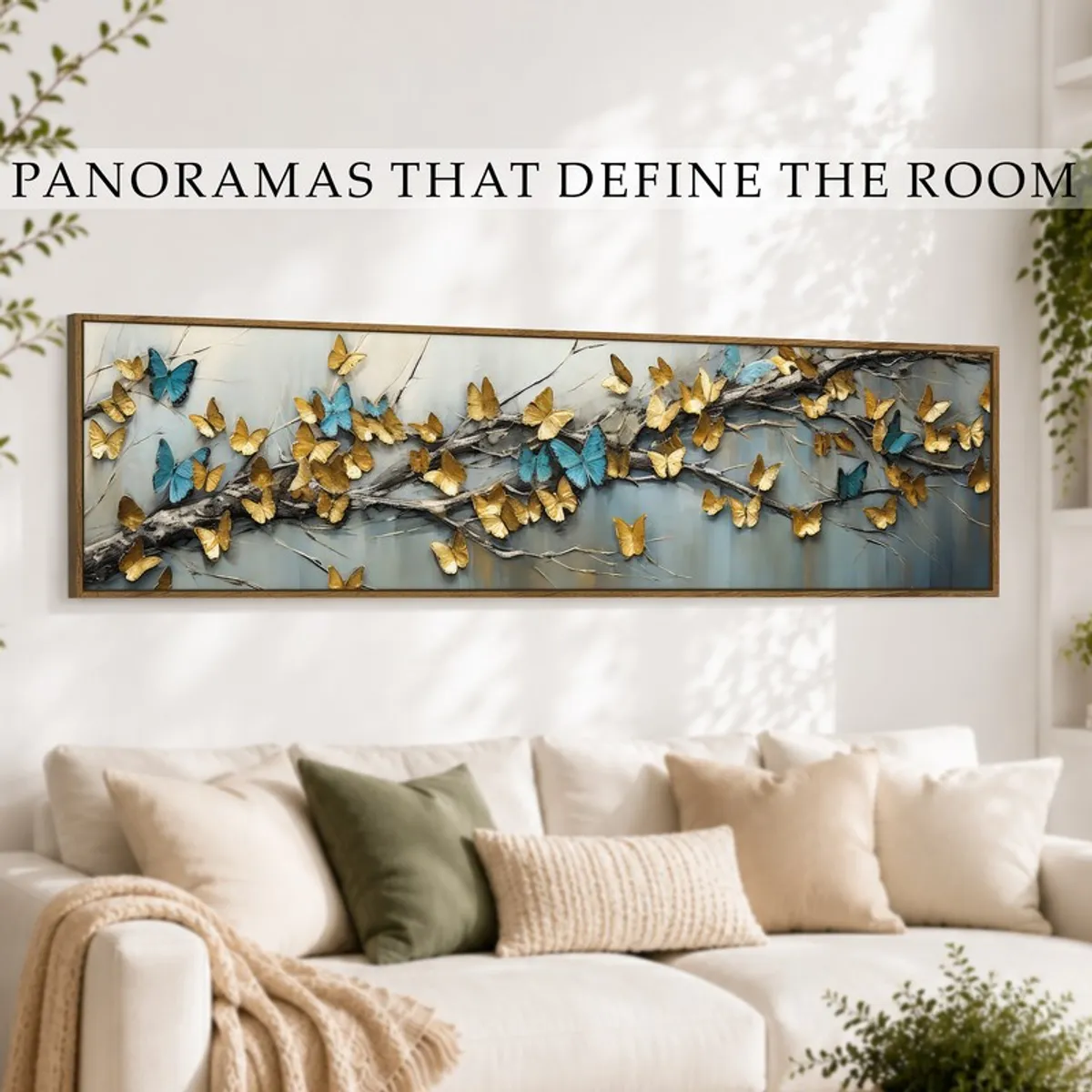 Wide framed butterfly wall art styled above a cream sofa