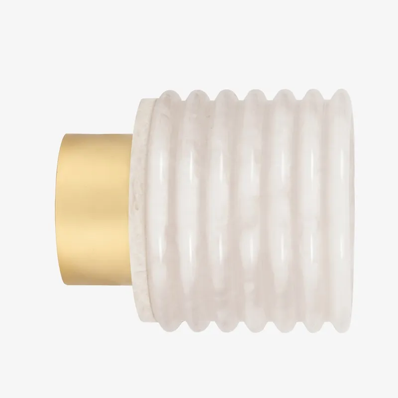 Side view of ribbed ivory wall lamp with cylindrical gold-toned base