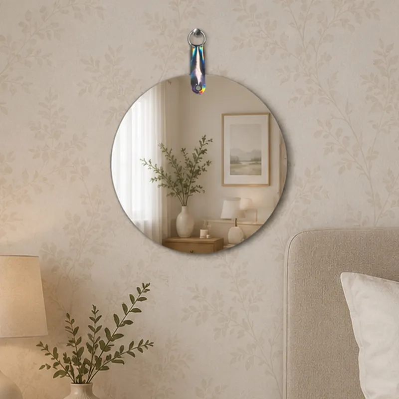 Round frameless wall mirror styled above a bedside table