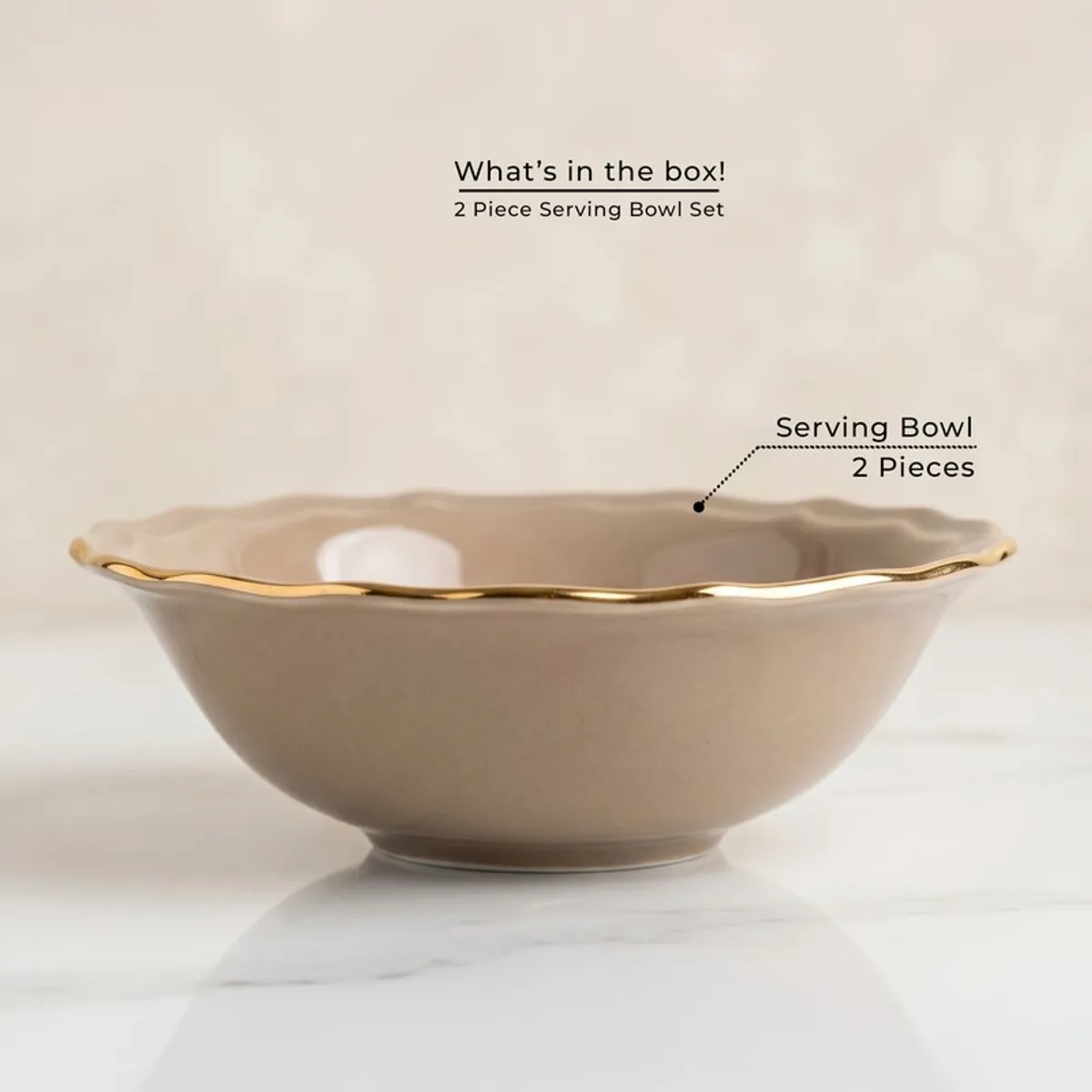 Single round grey serving bowl with a gold rim on a light background