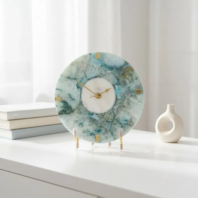 Round agate table clock with blue marbled finish and gold accents on a white console