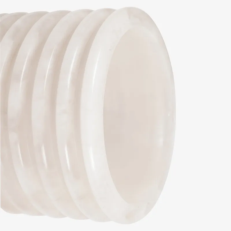 Close-up of the ribbed ivory shade on the wall lamp