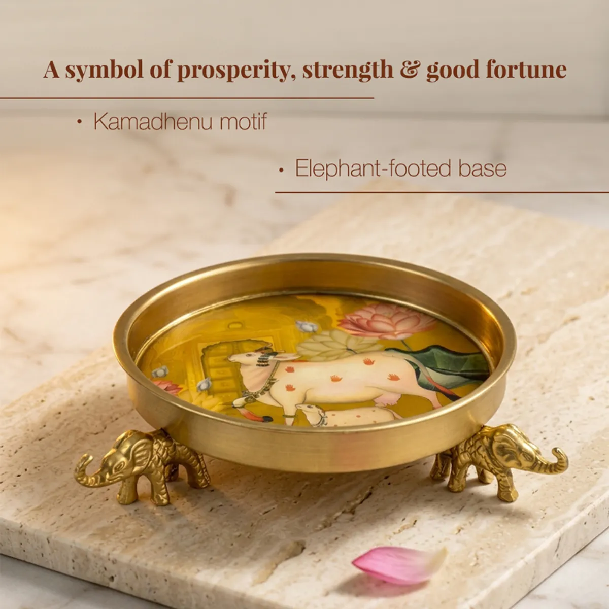 Gold Urli with elephant bases and colourful artwork displayed on a stone surface