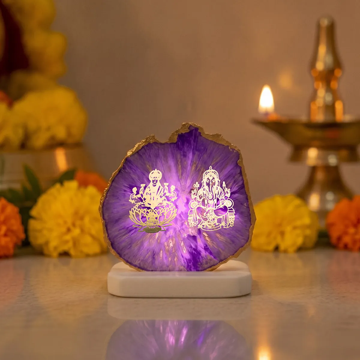 Purple agate Ganesha and Laxmi tealight holder glowing in a festive setting