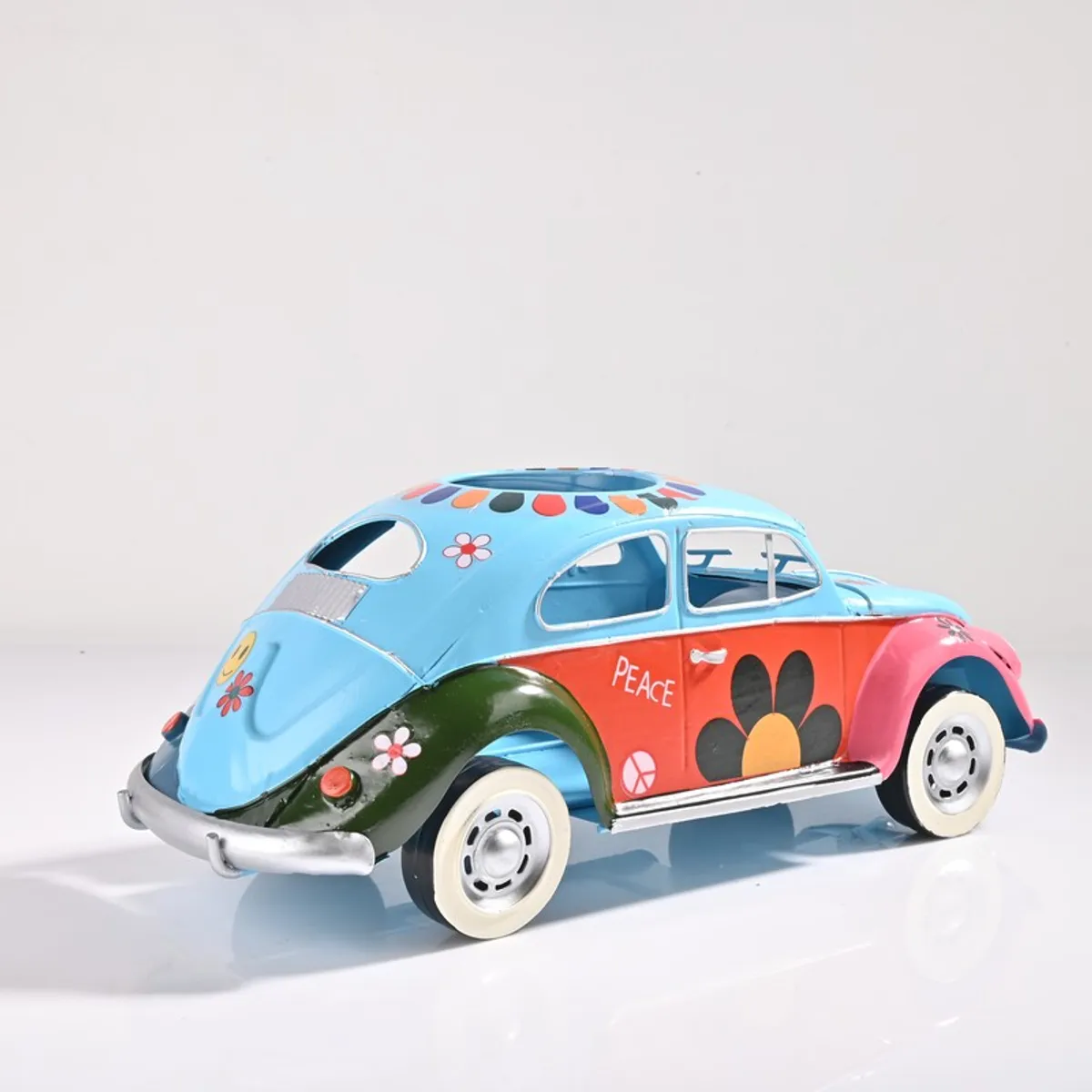 Rear angled view of multicolour vintage car showpiece with floral detailing
