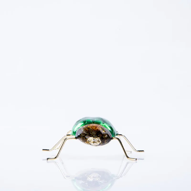 Front view of green and gold dung beetle showpiece