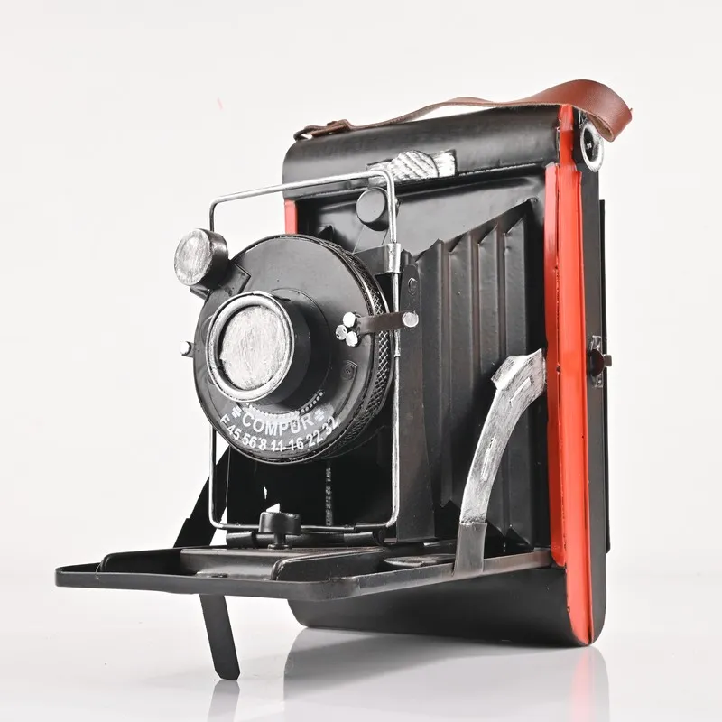 Front view of a black and red vintage camera showpiece