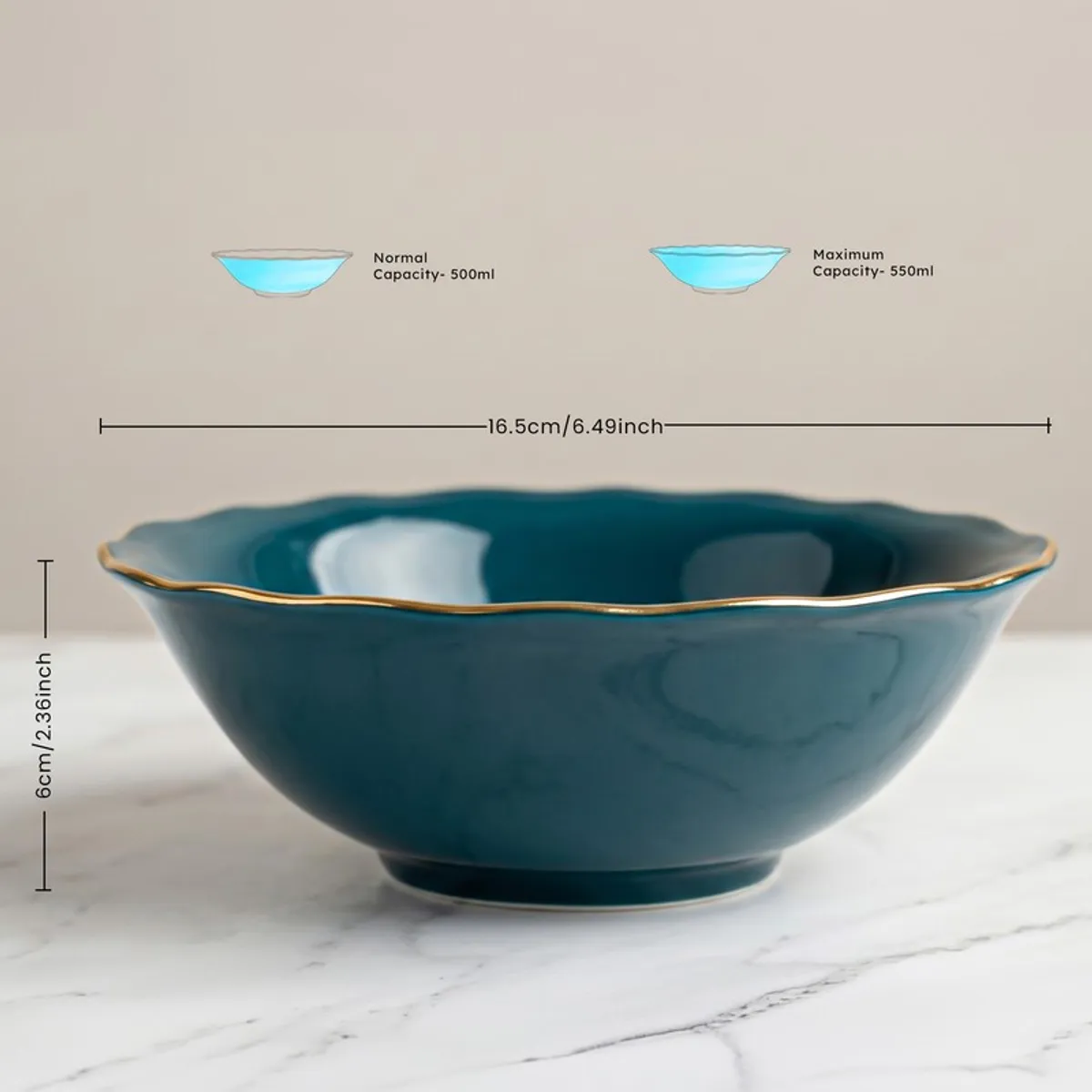 Dark teal serving bowl with scalloped rim and gold edge on a marble-look surface