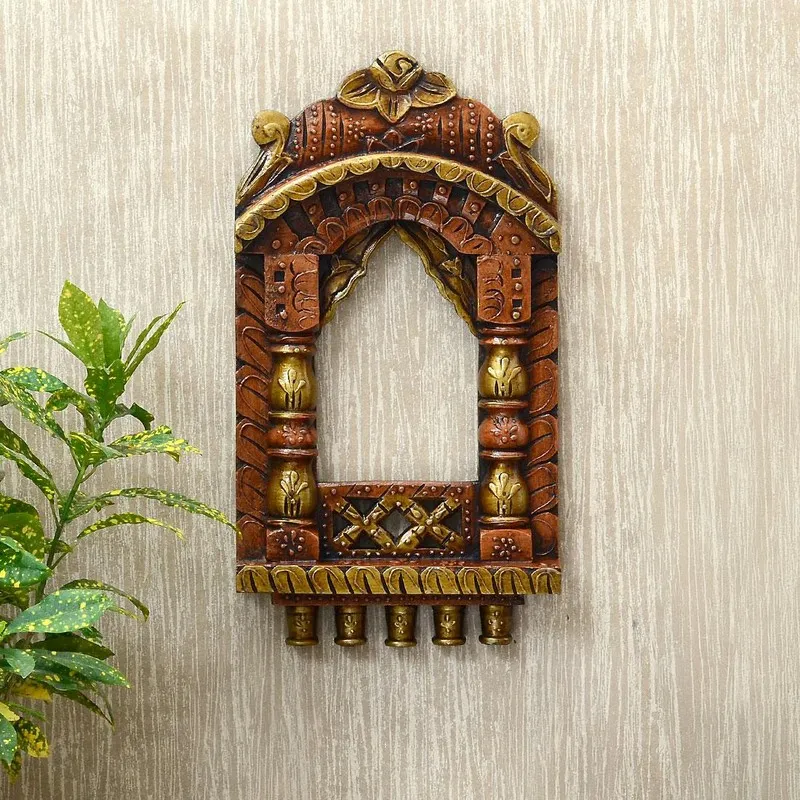 Front view of carved archway wall accent in brown and gold tones