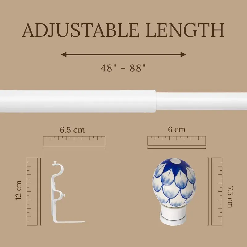 Extendable white curtain rod shown with blue floral finial and bracket