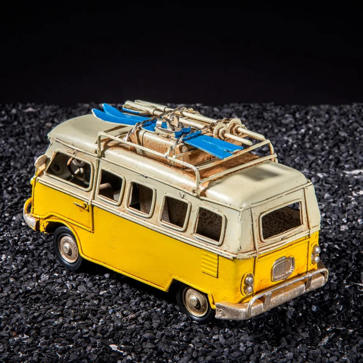 Rear angled view of yellow vintage bus showpiece with roof details