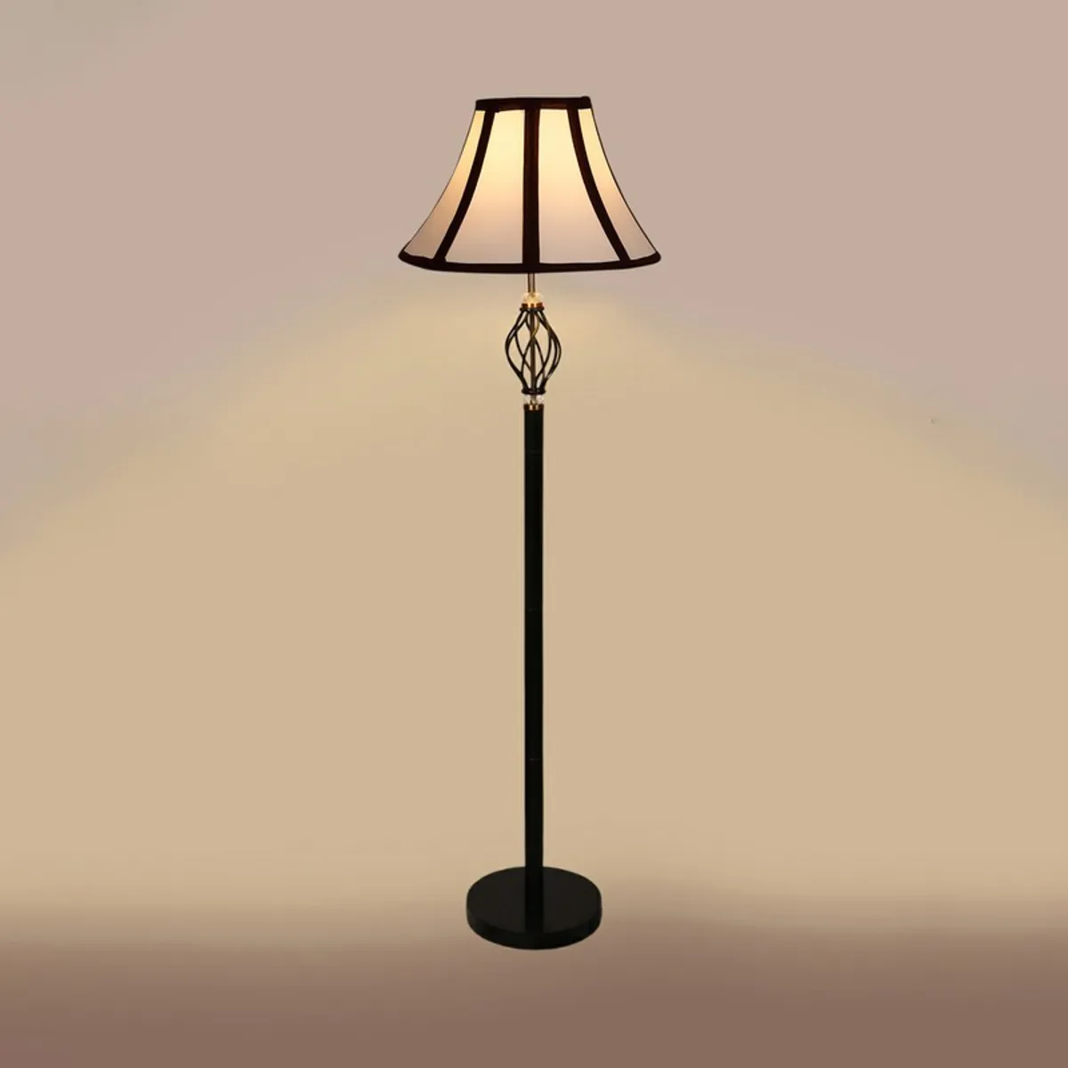 Black floor lamp with illuminated white paneled shade against a beige background