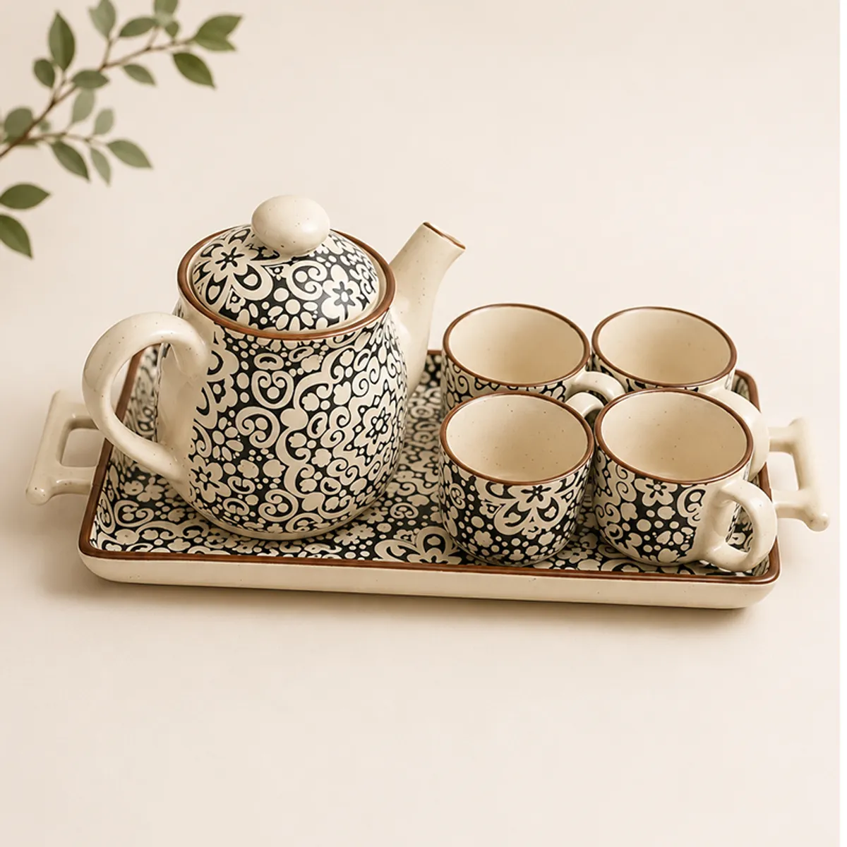 Ceramic tea set with ornate floral pattern arranged on a rectangular tray