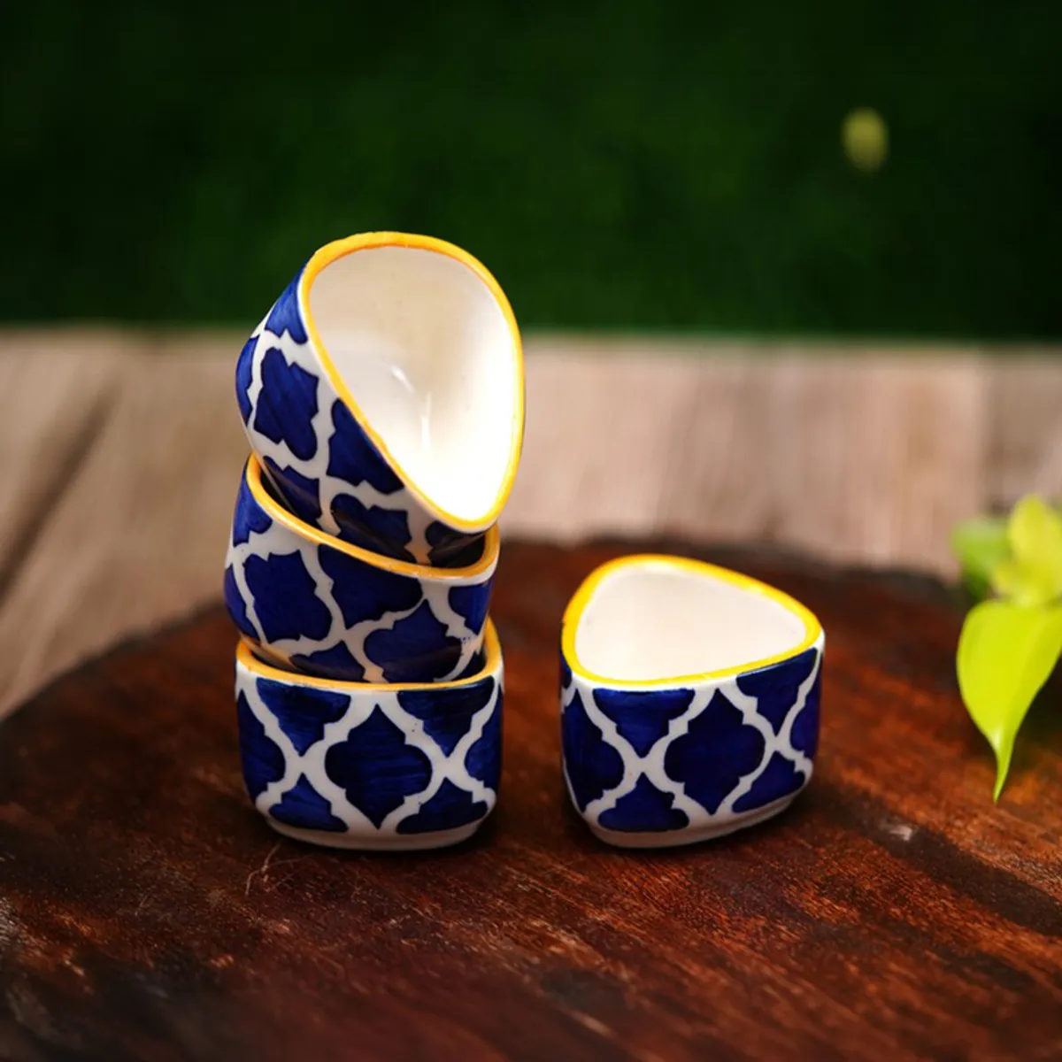 Stacked blue and white patterned dip bowls with yellow rim