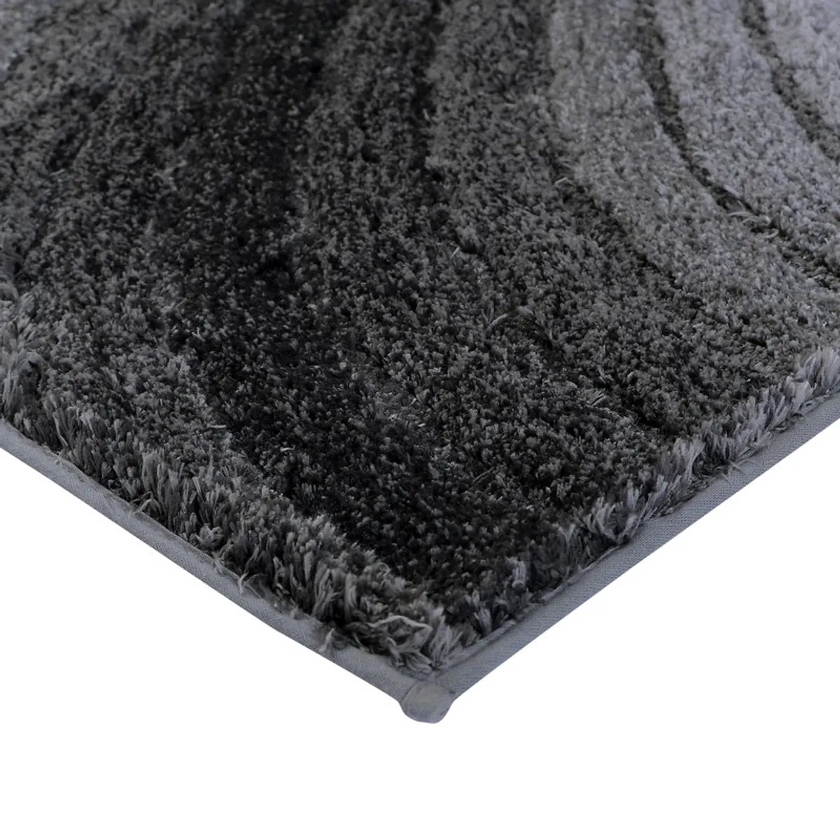 Close-up of the bath mat's soft textured grey and black surface