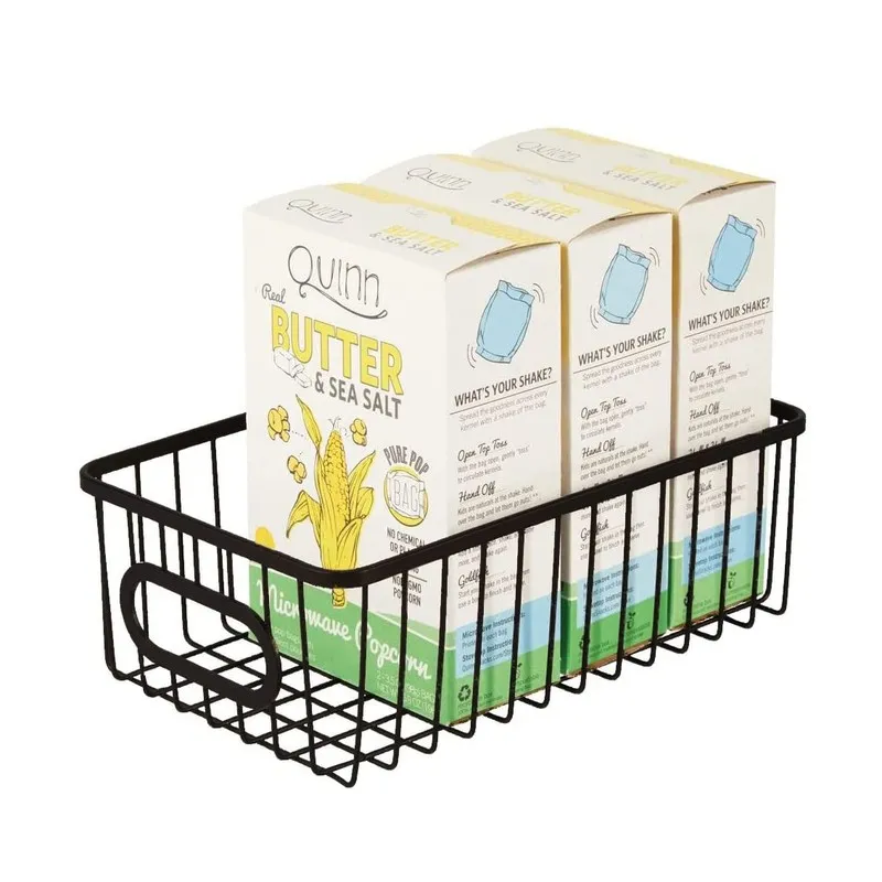 Black metal wire basket holding boxed pantry items