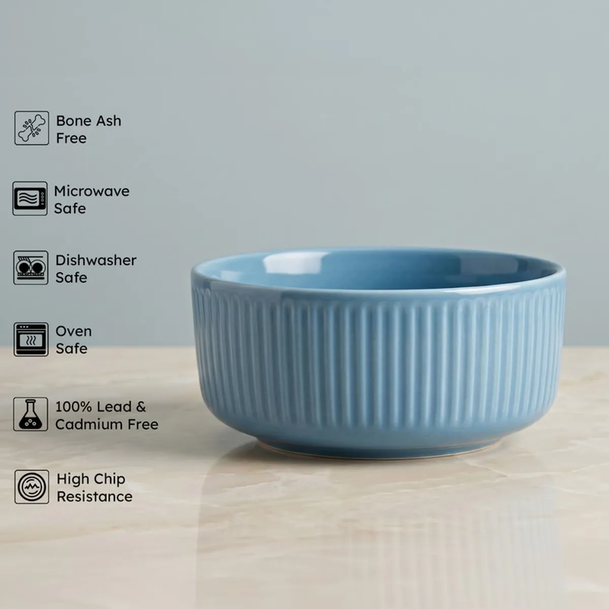Blue ribbed serving bowl with feature icons shown beside it