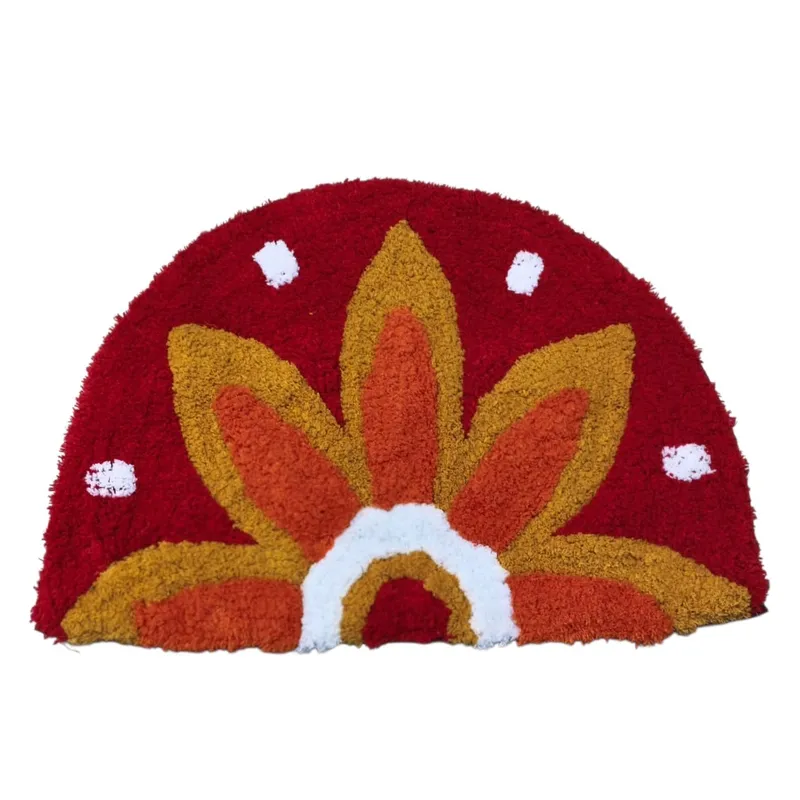 Red and orange sunflower bath mat displayed against a white background