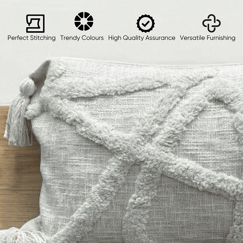 Close-up of grey tufted cushion cover texture with corner tassel