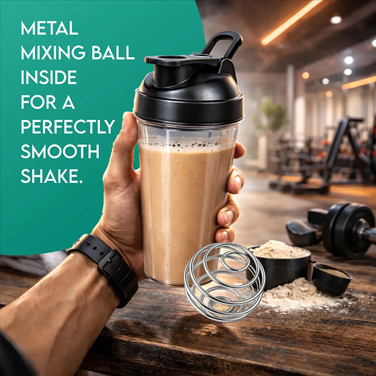 Person holding a transparent shaker bottle filled with a smoothie in a gym