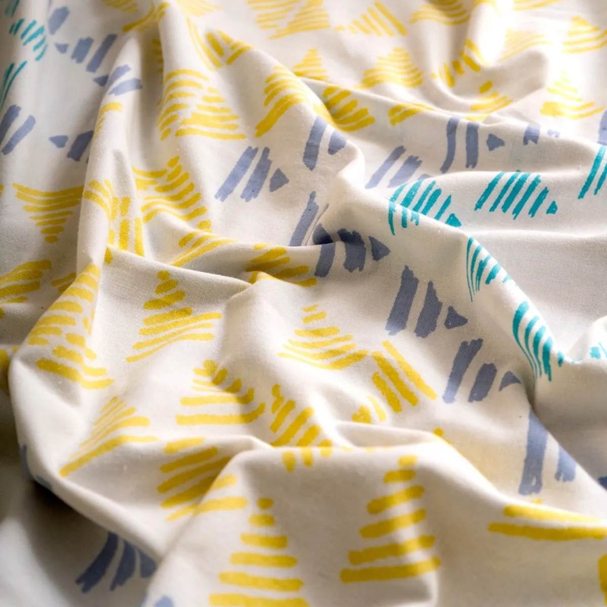 Close-up of soft white curtain fabric with colourful geometric print