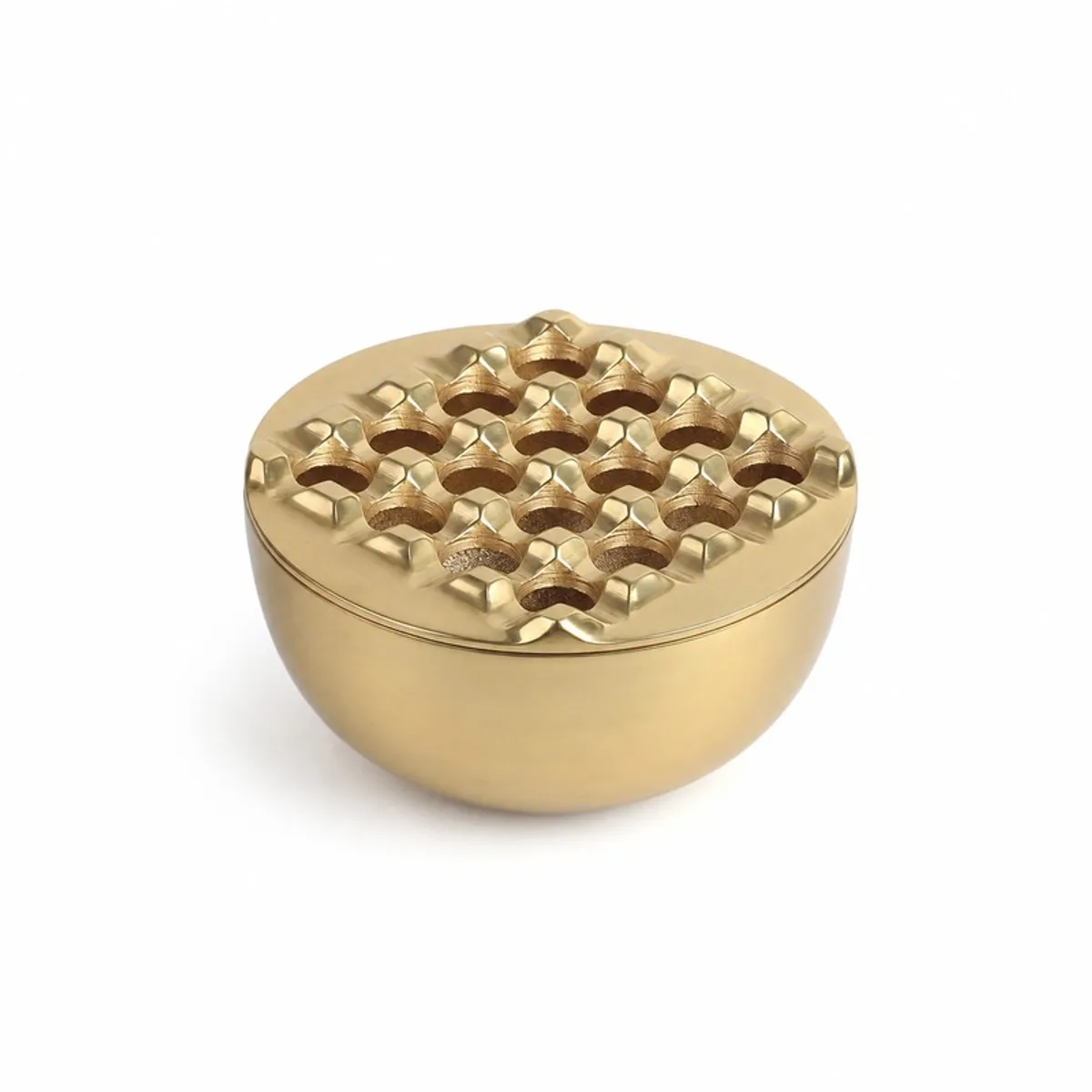 Closed gold ash tray with a raised sculpted patterned lid